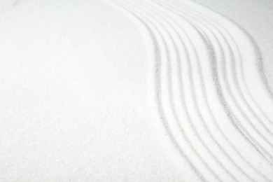 Photo of Zen rock garden. Wave pattern on white sand