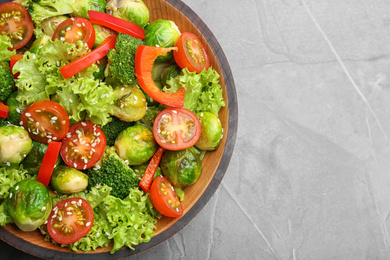 Tasty salad with Brussels sprouts on grey table, top view. Space for text