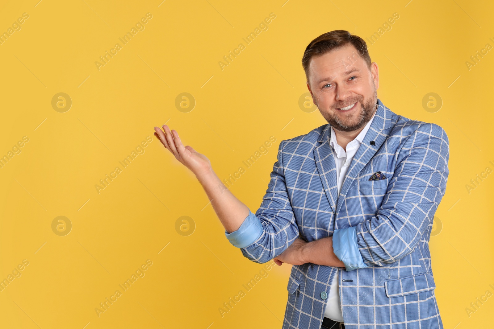 Photo of Portrait of happy mature man on yellow background, space for text