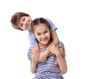 Happy brother and sister hugging on white background