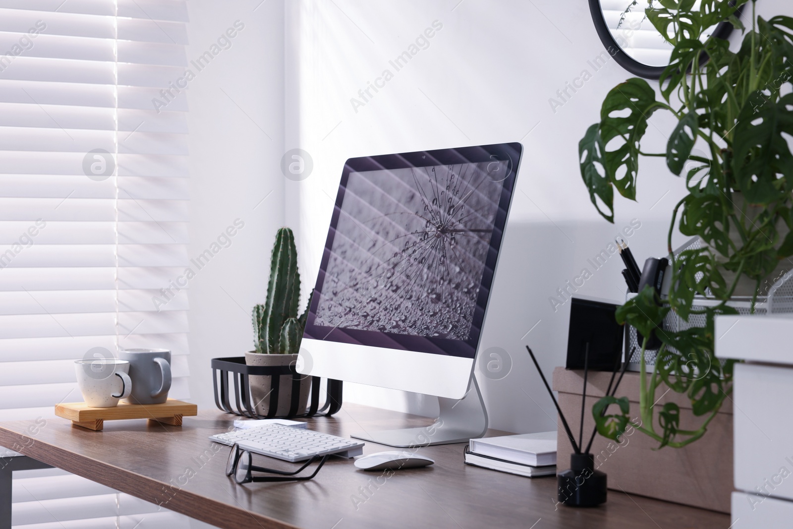 Photo of Cozy workspace with computer on wooden desk at home