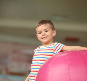 Cute little child playing at indoor amusement park