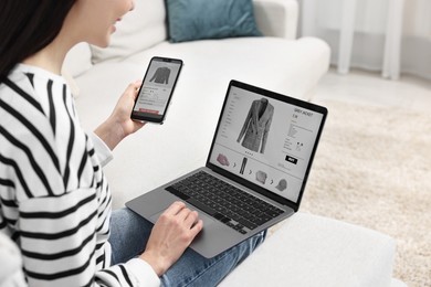 Photo of Woman with smartphone and laptop shopping online indoors, closeup