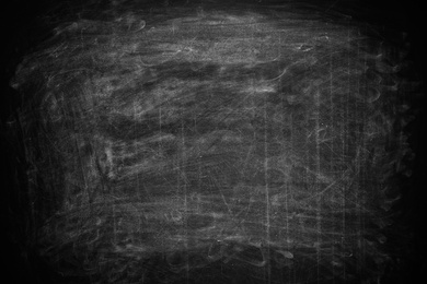 Photo of Chalk rubbed out on blackboard as background. Space for text