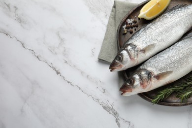 Tasty sea bass fish and spices on white marble table, top view. Space for text