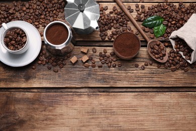 Photo of Flat lay composition with roasted coffee beans on wooden table. Space for text
