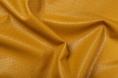 Beautiful yellow leather as background, top view