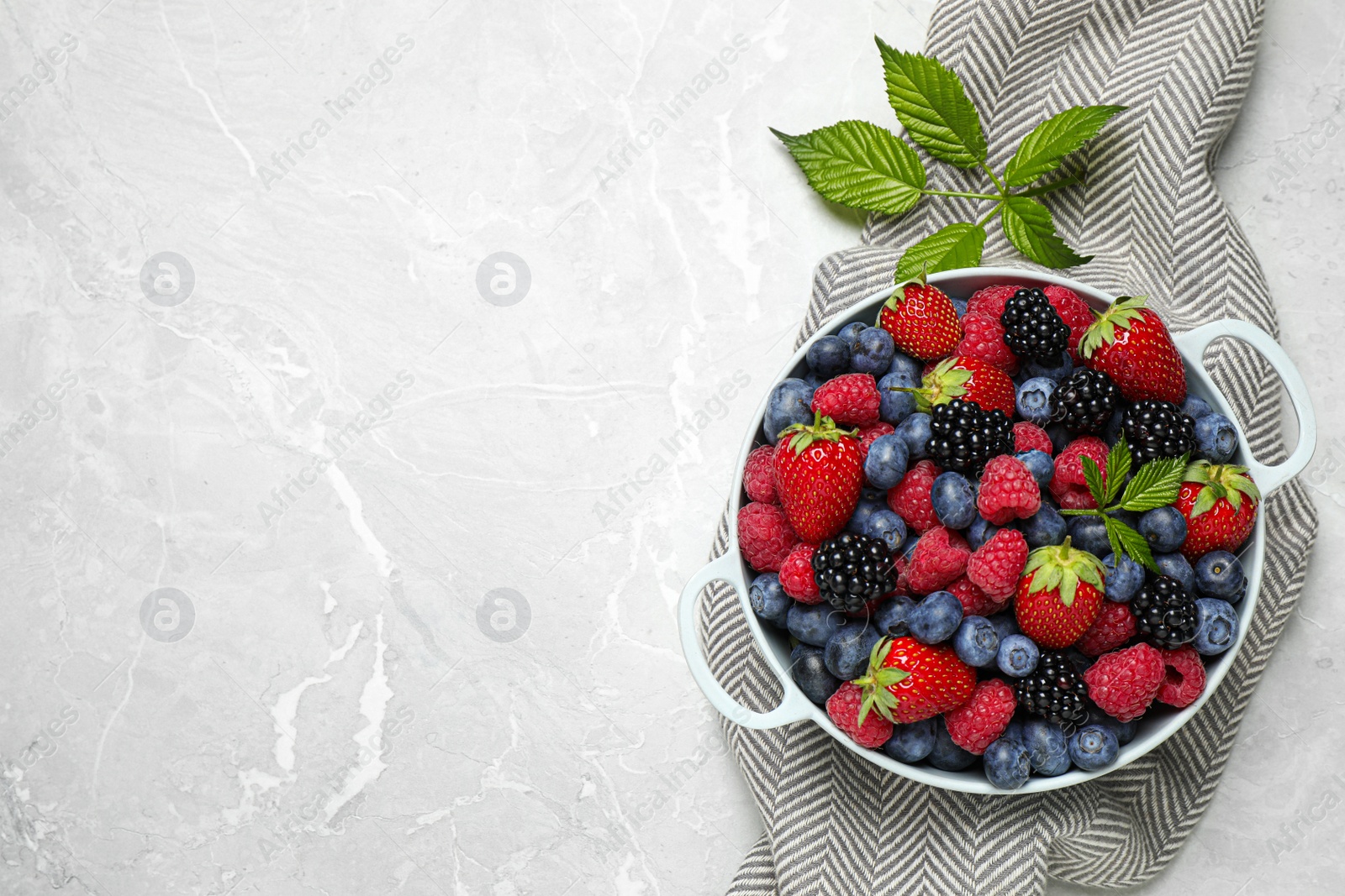 Photo of Mix of ripe berries on light table, flat lay. Space for text