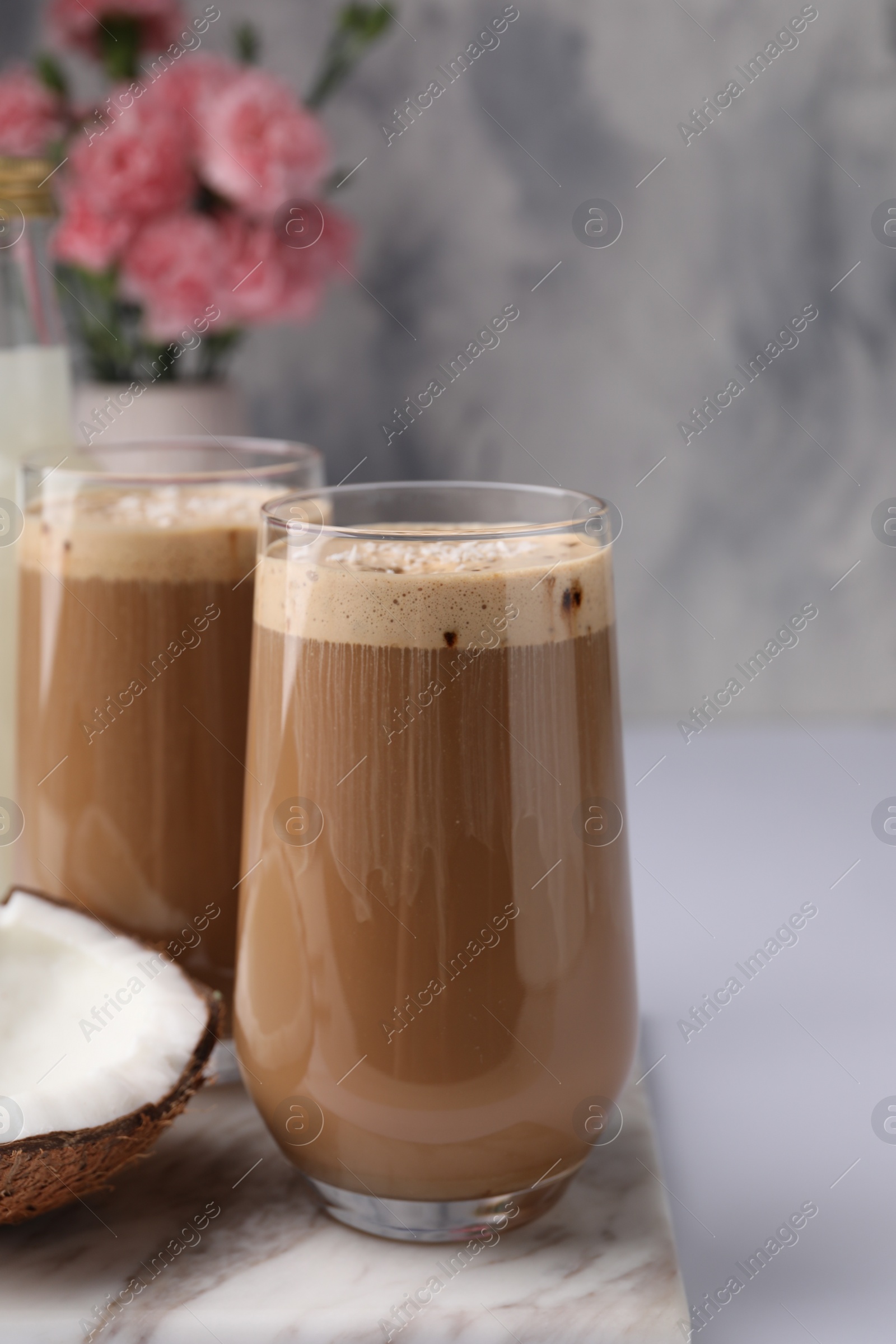 Photo of Delicious coffee with coconut syrup on white table