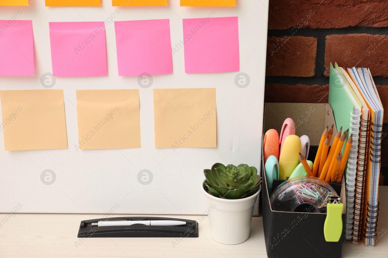 Photo of Business process planning and optimization. Workplace with colorful paper notes and other stationery on table