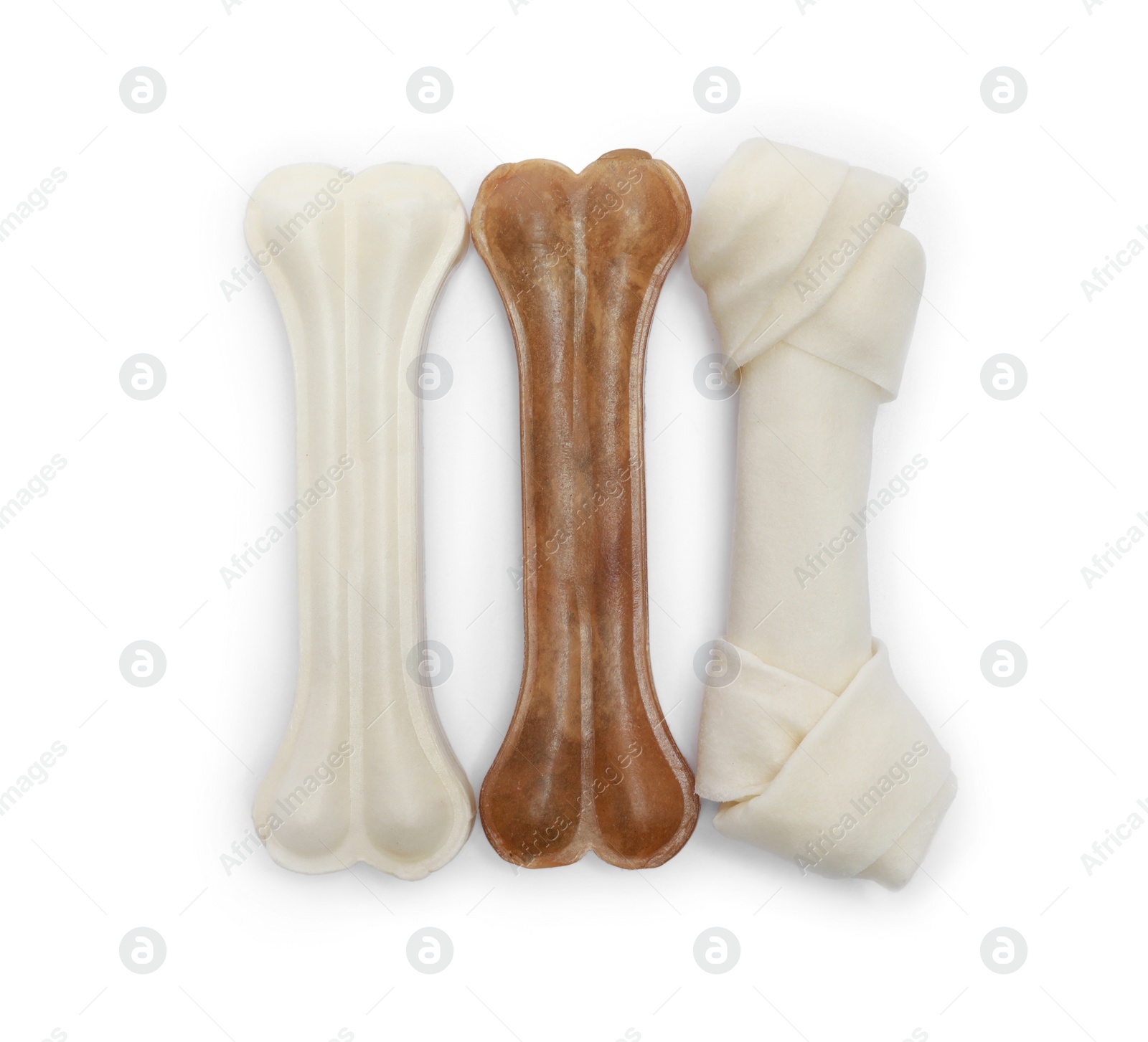 Photo of Different bone dog treats on white background, top view