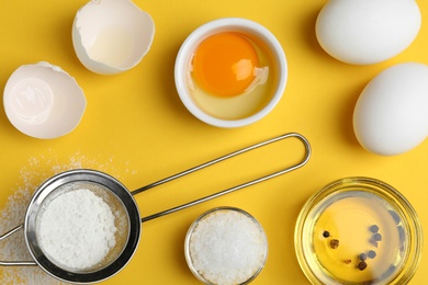 Photo of Flat lay composition with chicken eggs on yellow background