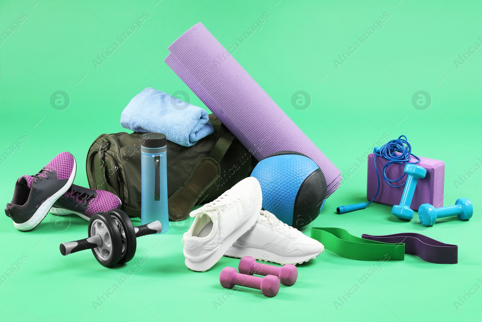 Photo of Many different sports equipment on green background