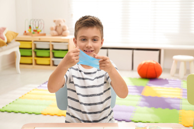 Little boy playing with slime in room