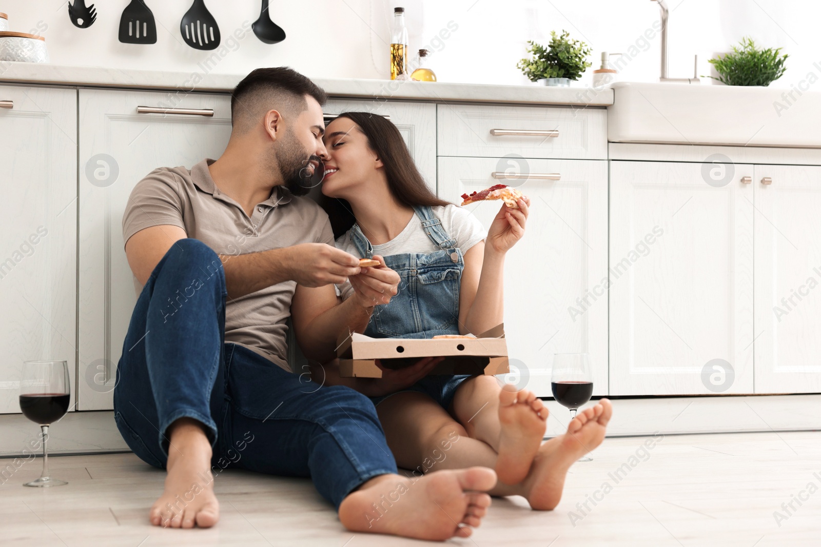 Photo of Happy young couple spending time together in kitchen. Space for text