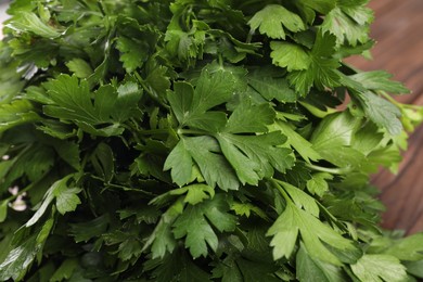 Photo of Fresh green parsley leaves on table, closeup