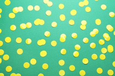 Photo of Confetti on green background, flat lay. Christmas celebration