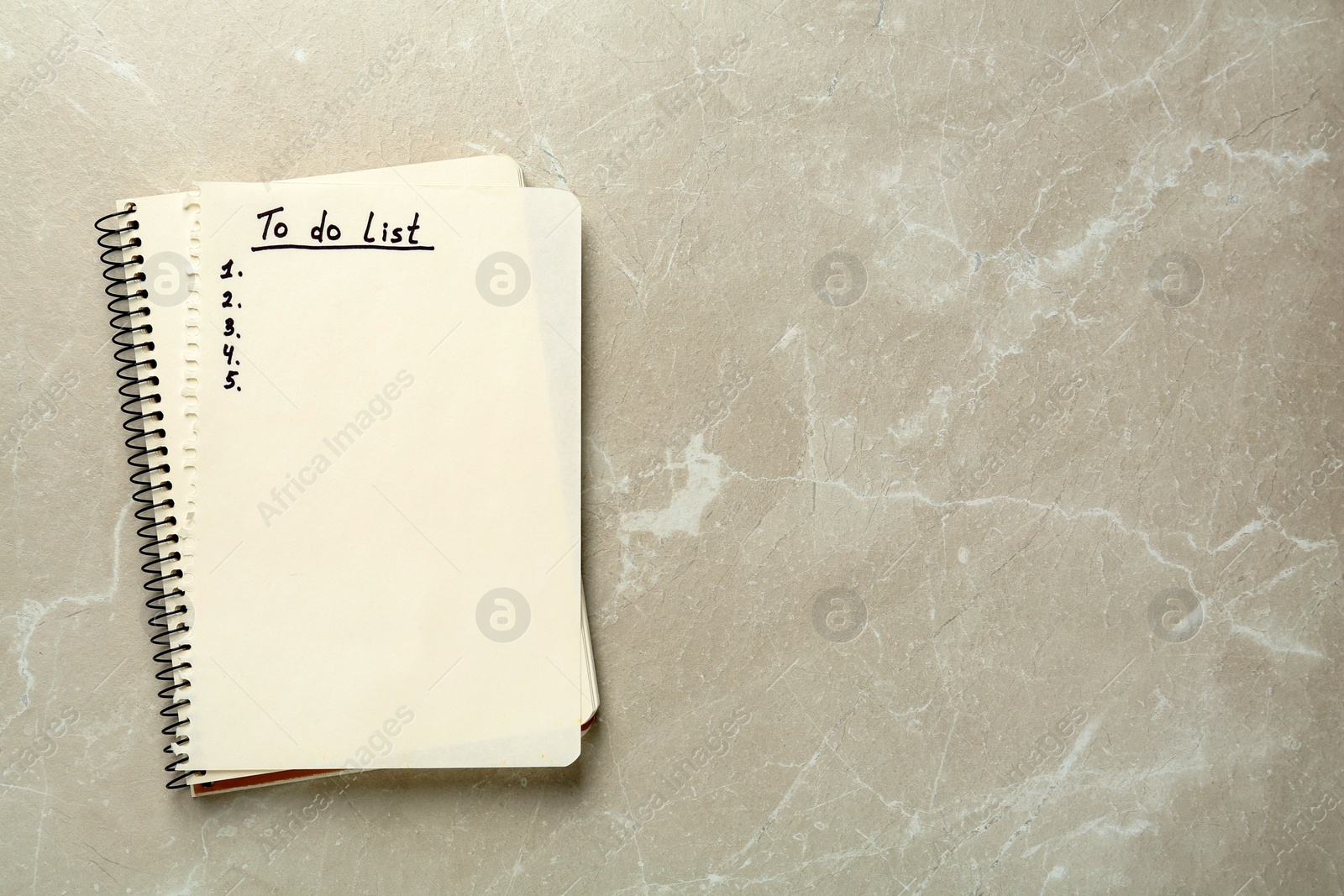 Photo of Notepad and torn sheet with unfilled To Do list on light grey marble table, top view. Space for text