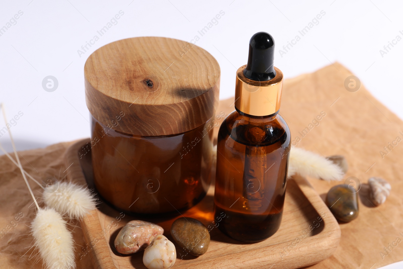 Photo of Composition with bottle of cosmetic serum on white background, closeup