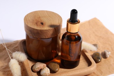 Photo of Composition with bottle of cosmetic serum on white background, closeup