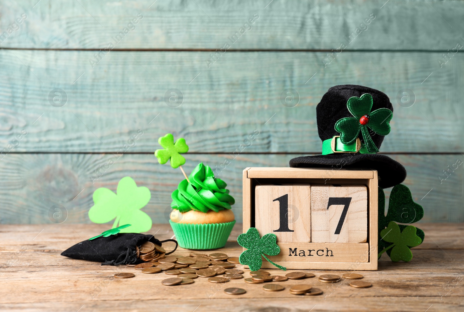 Photo of Composition with block calendar on wooden table. St. Patrick's Day celebration