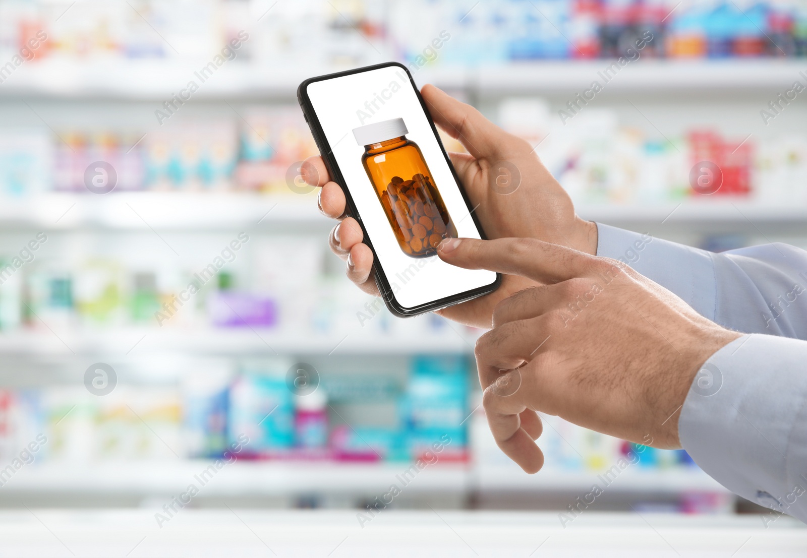 Image of Man with smartphone ordering medications online, closeup