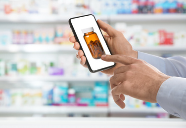 Man with smartphone ordering medications online, closeup