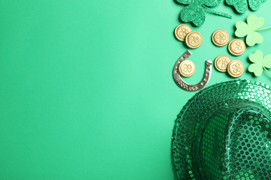 Flat lay composition with leprechaun hat on green background, space for text. St. Patrick's Day celebration