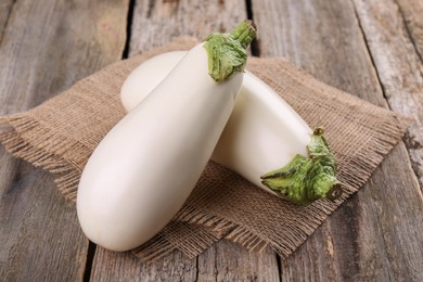 Photo of Two fresh white eggplants on wooden table