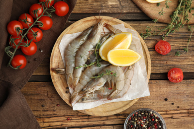 Flat lay composition with raw shrimps on wooden table