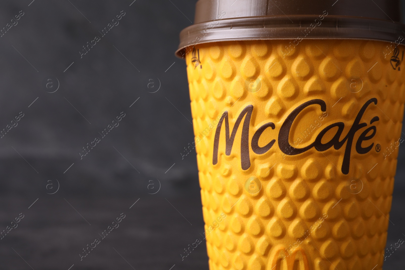 Photo of MYKOLAIV, UKRAINE - AUGUST 12, 2021: Hot McDonald's drink on grey background, closeup