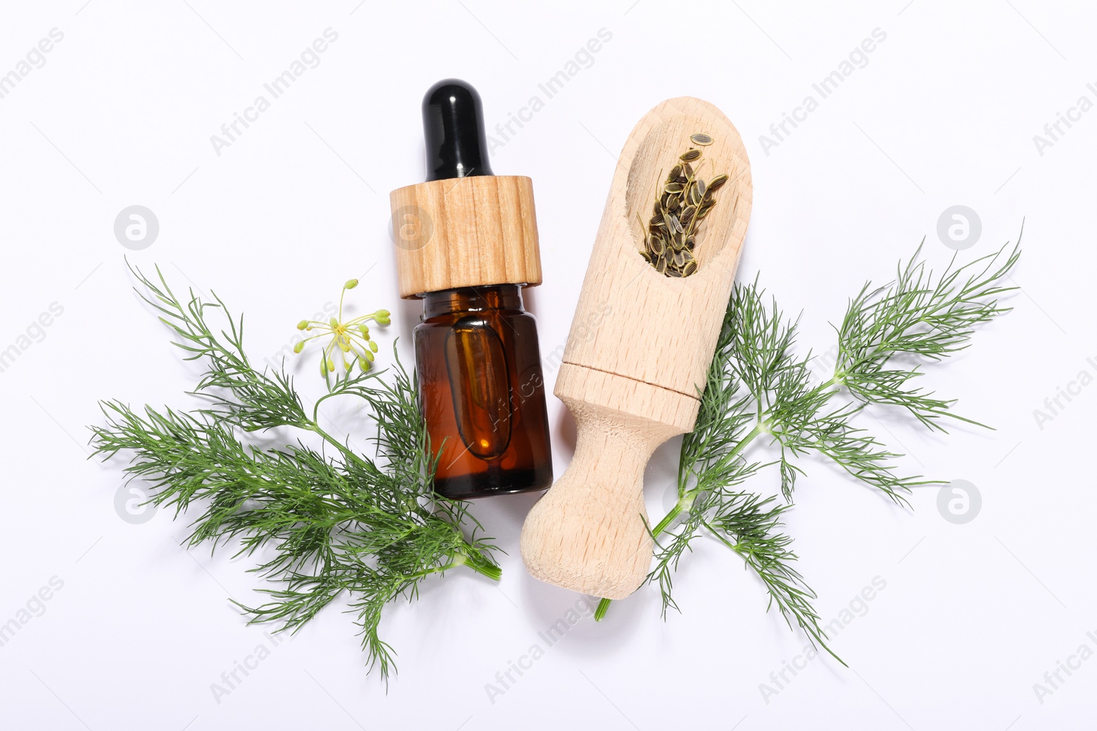 Photo of Bottle of essential oil and scoop with fresh dill on white background, flat lay