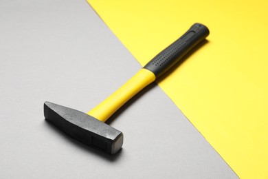 Photo of New hammer with rubber handle on color background