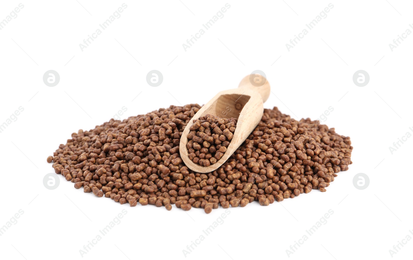 Photo of Buckwheat tea granules and wooden scoop on white background