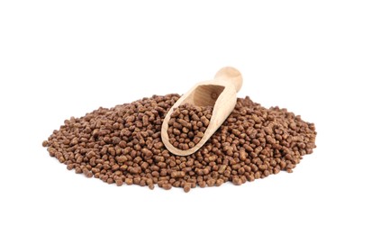 Buckwheat tea granules and wooden scoop on white background