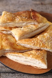 Delicious puff pastry on wooden table, closeup