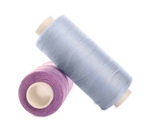 Photo of Different colorful sewing threads on white background