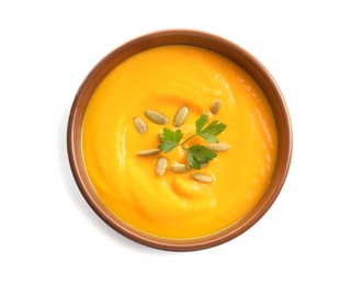 Delicious pumpkin cream soup in bowl on white background, top view