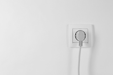 Photo of Power socket and plug on white background. Electrician's equipment