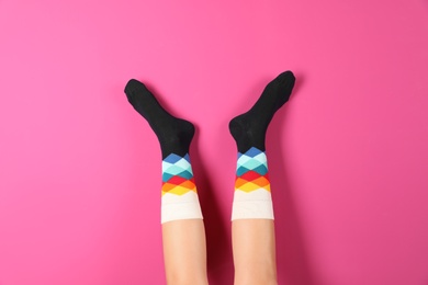 Photo of Woman wearing stylish socks on color background