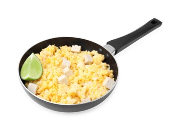 Photo of Frying pan with delicious scrambled eggs, tofu and lime isolated on white