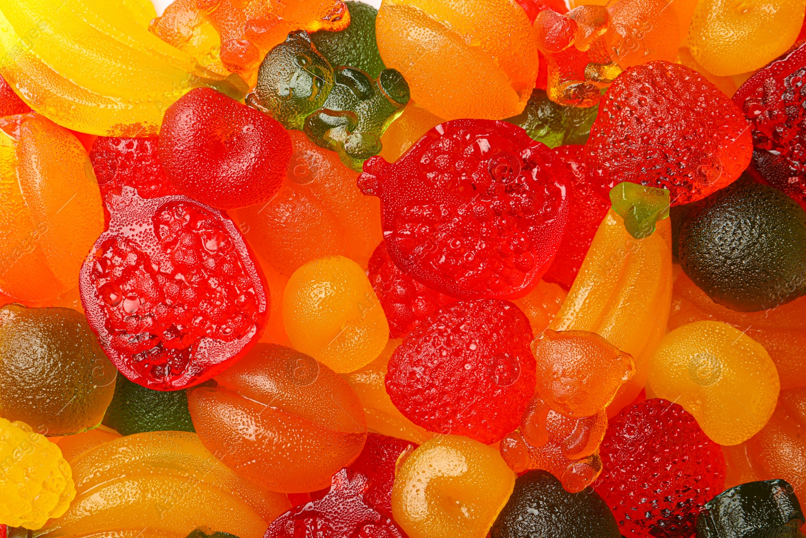 Photo of Mix of different delicious gummy candies as background, top view