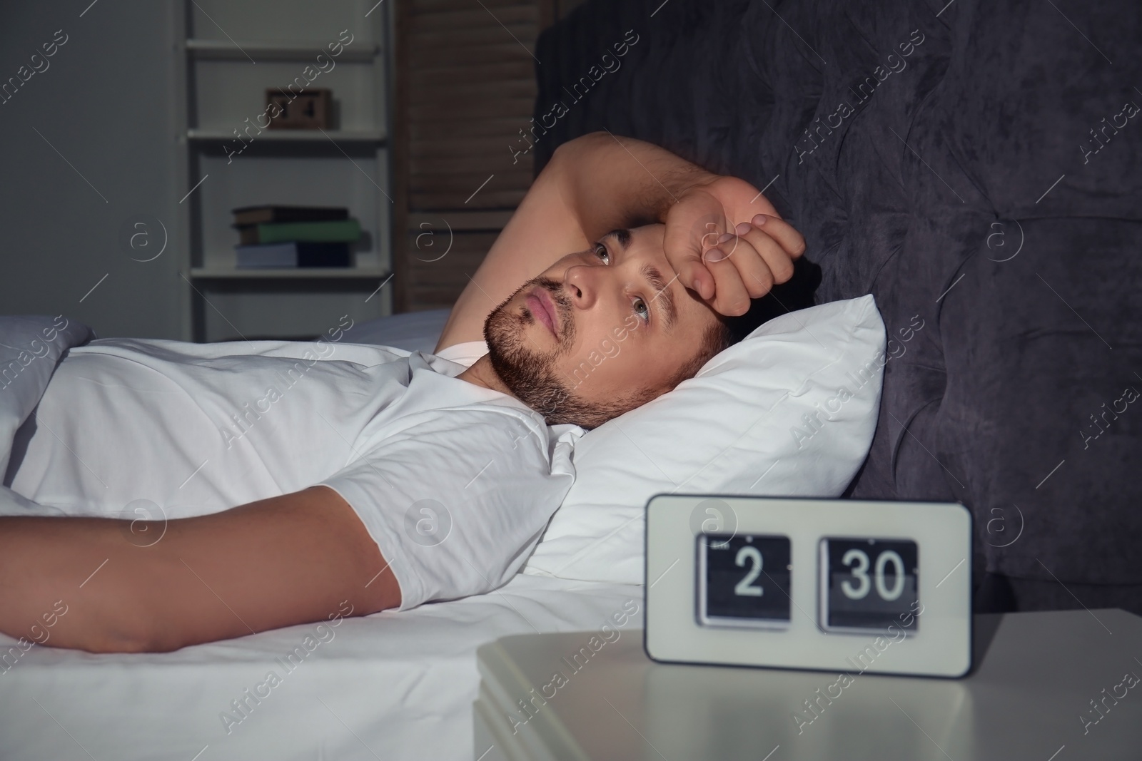 Photo of Man suffering from insomnia in bed at home