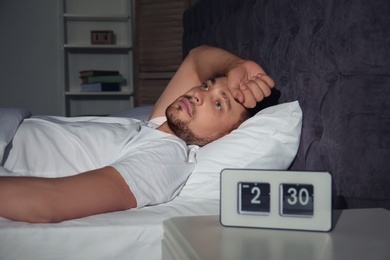 Photo of Man suffering from insomnia in bed at home