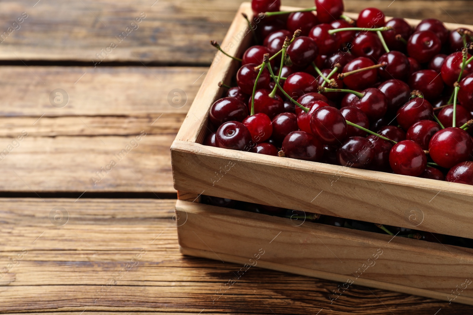 Photo of Sweet juicy cherries on wooden table, closeup
