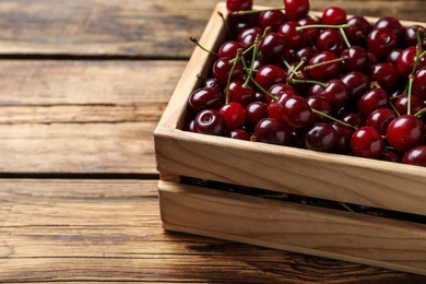 Sweet juicy cherries on wooden table, closeup
