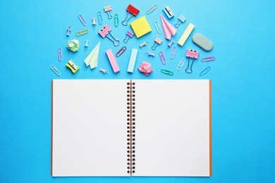 Photo of Back to school. School stationery and paper planes near notebook on light blue background, flat lay