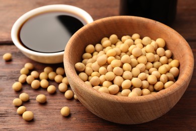 Photo of Soybeans in bowl on wooden table, closeup