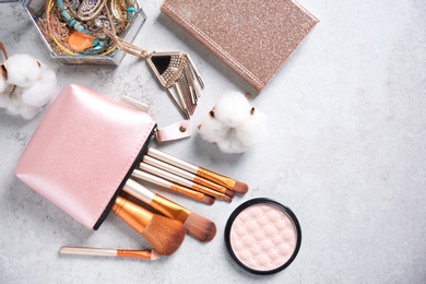 Photo of Flat lay composition with professional makeup brushes on light background