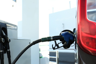 Photo of Modern car refilling with fuel at gas station